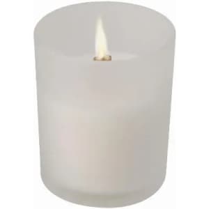 A frosted glass candle holder with a lit candle inside, featuring a soft white wax.