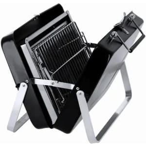 A portable charcoal barbecue grill in black with a silver stand, featuring a removable cooking grate.