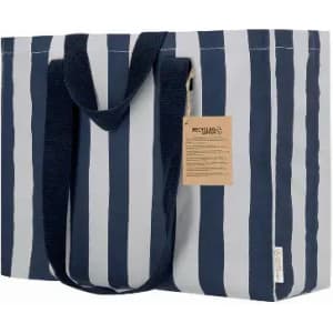 A striped tote bag featuring navy and white vertical stripes, with sturdy handles and a tag attached.