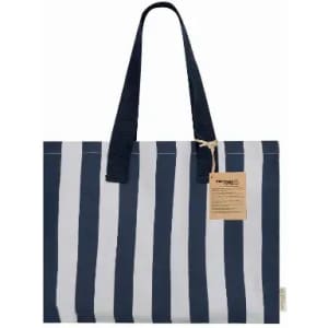 A striped tote bag in navy blue and white, featuring sturdy handles and a small tag.
