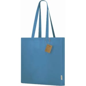 A blue tote bag with long handles and a tag. The bag features a simple, modern design.