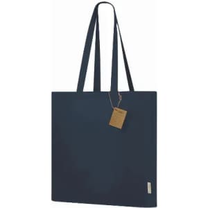 A tote bag in navy blue with long handles and a tag attached. The bag features a simple, minimalistic design.