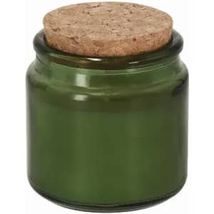 A green glass jar with a cork lid. The jar has a smooth surface and a round shape.