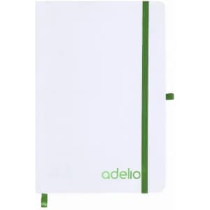 A white notebook with a green elastic band and two green ribbon bookmarks. It has branding on the front cover.