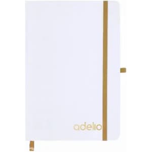 A white notebook with a gold elastic band and an embossed logo on the cover.
