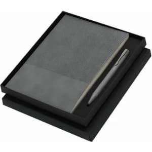 A gift set featuring a black notebook with a textured cover and a matching grey pen, presented in a black box.