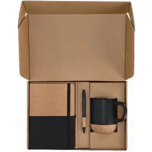 A gift box containing a cork-covered notebook, a black mug with a cork base, and a black pen.