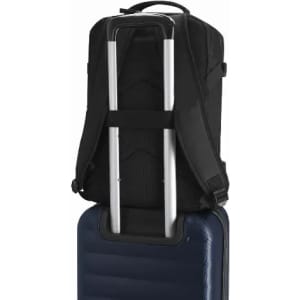 A black backpack with a supportive back panel, positioned on top of a blue suitcase, featuring a metallic handle.