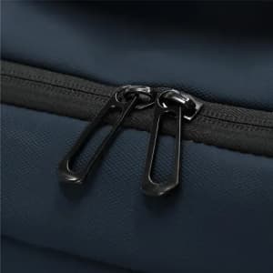 A close-up of a dark blue bag featuring a black zipper with two zip pullers.