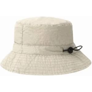 A light beige bucket hat with a textured finish and an adjustable tie on the side.