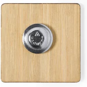 A square bamboo coaster with a metallic base. The coaster features a round silver button in the centre.