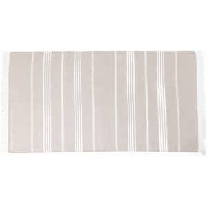 A striped beige towel with white lines and fringe detailing. It has a soft texture and a rectangular shape.