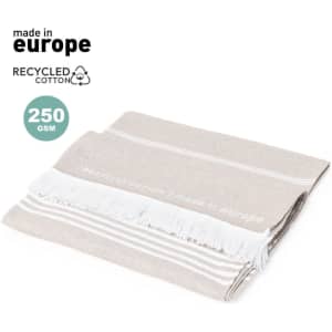 A beige and white striped towel made from recycled cotton, featuring fringed edges and a branding logo.