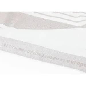 A light grey, textured fabric with a subtle pattern and a logo on one side.