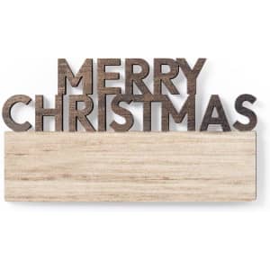 A wooden sign featuring the words "Merry Christmas" in bold letters, with a natural wood base.