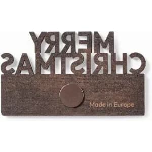 A decorative wall plaque with "MERRY CHRISTMAS" in cut-out letters and a circular hook at the bottom. It has a brown finish.