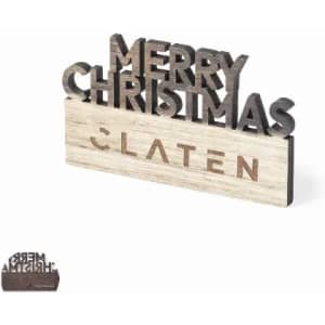 A decorative wooden sign featuring "Merry Christmas" in black lettering on a light wooden base, with a logo present.