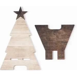 Two wooden cutouts, one shaped like a Christmas tree with a star and the other a simple geometric form, in light and dark wood colours.