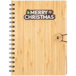 A bamboo notebook with a spiral binding and a button closure, featuring a festive 'Merry Christmas' design.