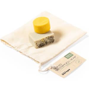 A solid shampoo soap set featuring a yellow bar and a cream bar with black speckles, presented in a fabric pouch.