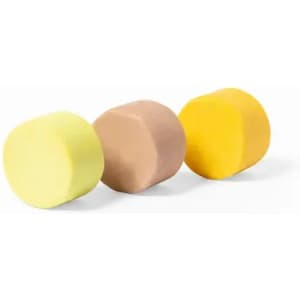 Three cylindrical blocks of play dough in yellow, brown, and light beige, each with a smooth surface.