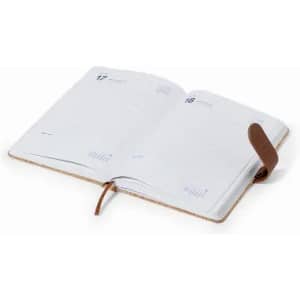 An open planner with blank pages, featuring a brown leather strap closure and a minimalistic design.