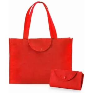 A red tote bag and a matching foldable pouch, both with simple designs and a snap button closure.