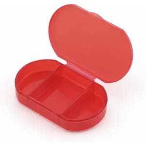 A red pill organiser with two compartments, featuring a hinged lid. It has a transparent design.