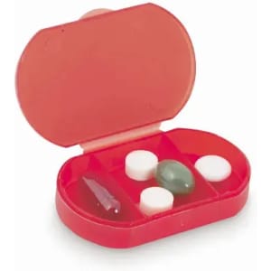 A pill organiser with a red case, featuring three compartments containing various pills in different shapes and sizes.