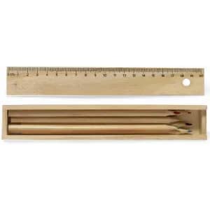 A wooden pencil case containing three coloured pencils and a wooden ruler on top.