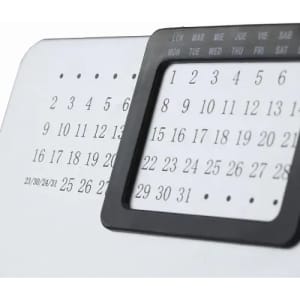 A desk calendar featuring a black frame and numerical dates displayed in black and white.