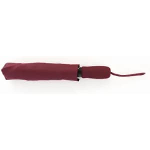 A maroon umbrella is closed and appears compact, featuring a black handle and a strap for carrying.