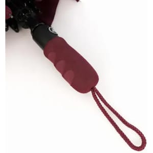 A burgundy umbrella with a black handle and a matching wrist strap for easy carrying.