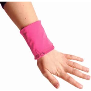 A pink wristband is worn on a wrist, featuring a zip closure and a soft fabric design.