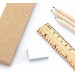 A flat ruler, a white eraser, three wooden pencils, and a brown cardboard box are displayed together.
