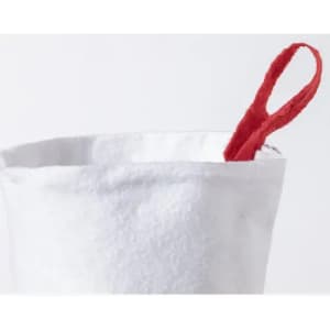 A white container with a red fabric handle peeking out from the top.