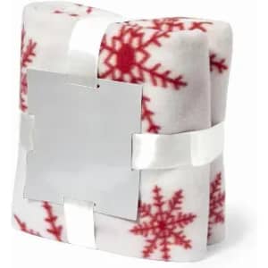 A wrapped gift featuring a soft, white blanket with red snowflake patterns, secured with a silver ribbon.