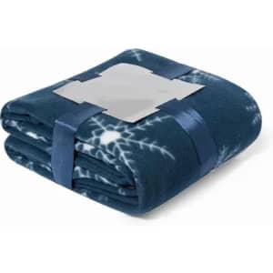 A folded blue fleece blanket with a snowflake pattern, neatly tied with a blue ribbon and featuring a logo.