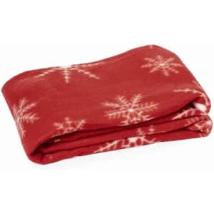 A red fleece blanket featuring a snowflake pattern, neatly folded. The fabric appears soft and warm.