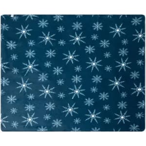 A blue placemat with a star pattern, featuring white stars and snowflakes throughout the surface.