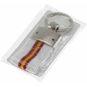 A keyring with a silver metal clasp and a white fabric strap featuring red and gold stripes, packaged in a clear wrapper.