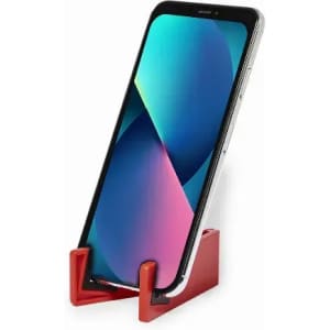 A phone holder in red, featuring a sleek design, supporting a smartphone in an upright position.