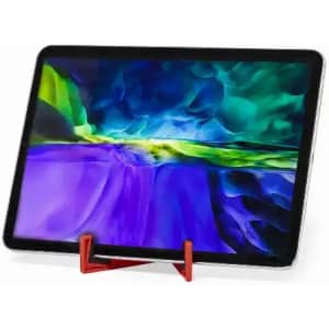 A tablet displayed on a red stand, featuring a vibrant abstract screen of blue, green, and purple hues.