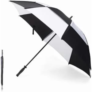 A black and white striped umbrella stands open, next to a closed black umbrella. Both have a sleek design.