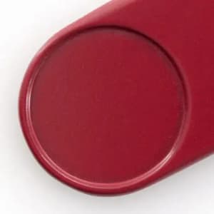 A drink bottle cap in a deep red colour, featuring a smooth circular design and a slight raised edge.