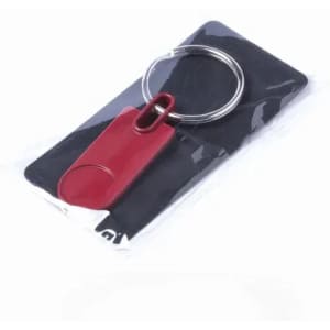 A red keychain bottle opener with a ring, packaged on a black backing.