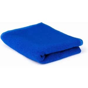 A folded blue towel, showcasing a soft texture, with a neat edge. The towel is lying on a white background.