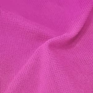 A close-up of a textured, bright pink gym towel featuring a subtle logo design.