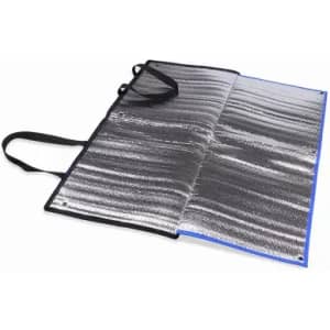 A picnic blanket in silver with black straps, featuring a reflective surface and foldable design.