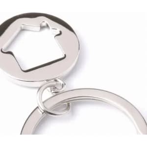 A keyring featuring a metallic circular design with a house-shaped cutout. The keyring is shiny silver in colour.